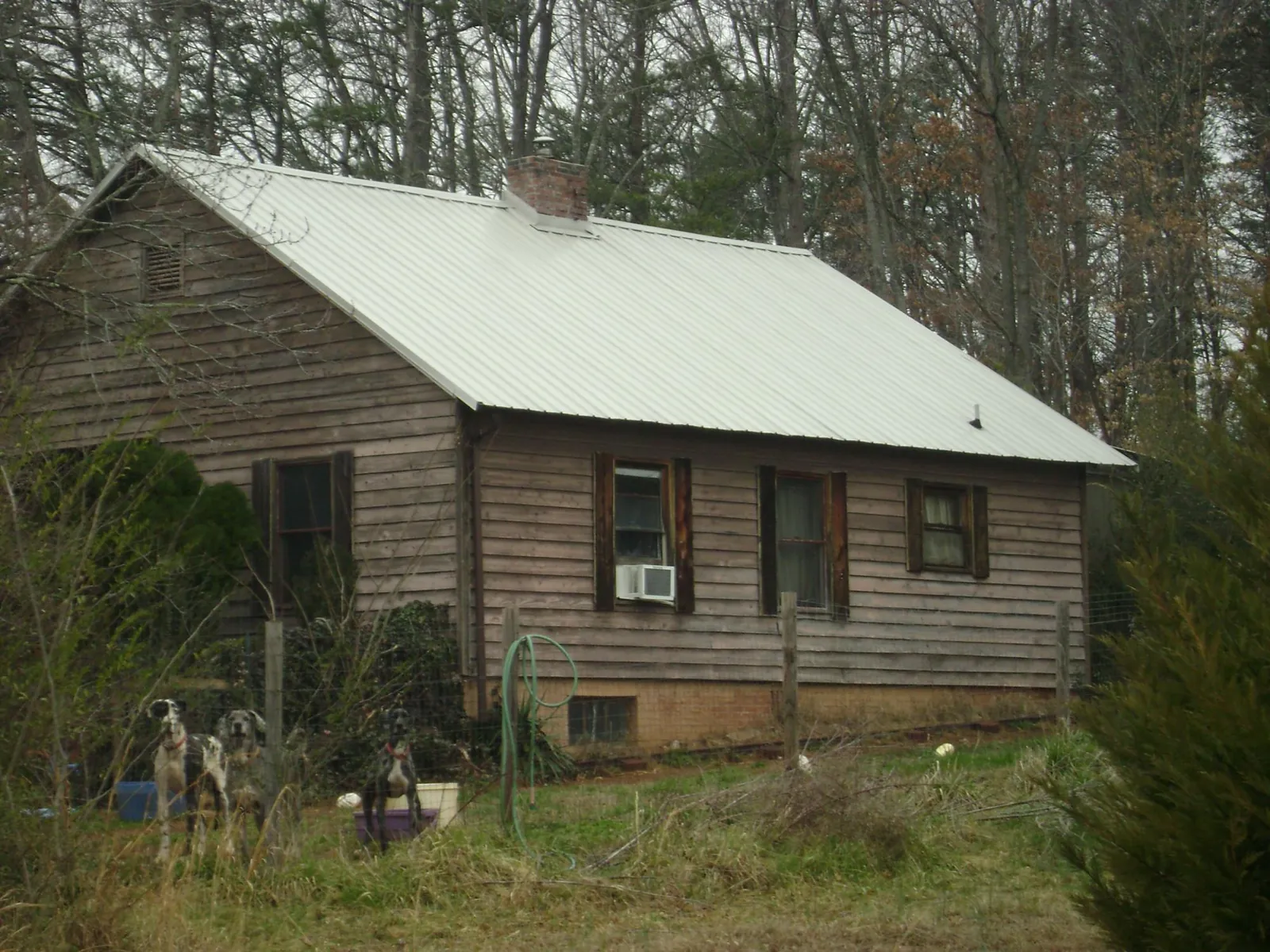 White metal roof on an old wood sided farmhouse, from a Metal Roof Installation job in Franklin